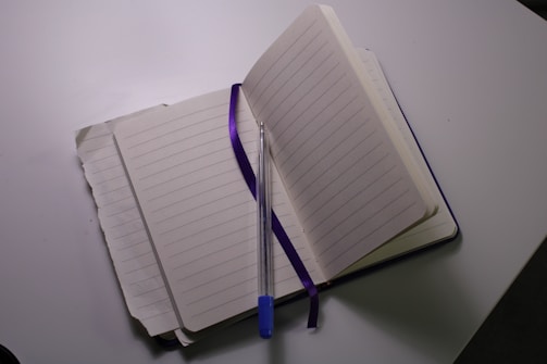 An open notebook with a pen, representing planning and choices.