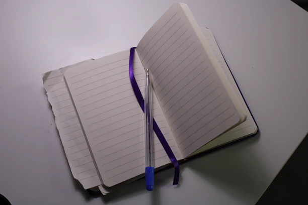 An open notebook with a colorful life wheel diagram and a pen resting on the page.