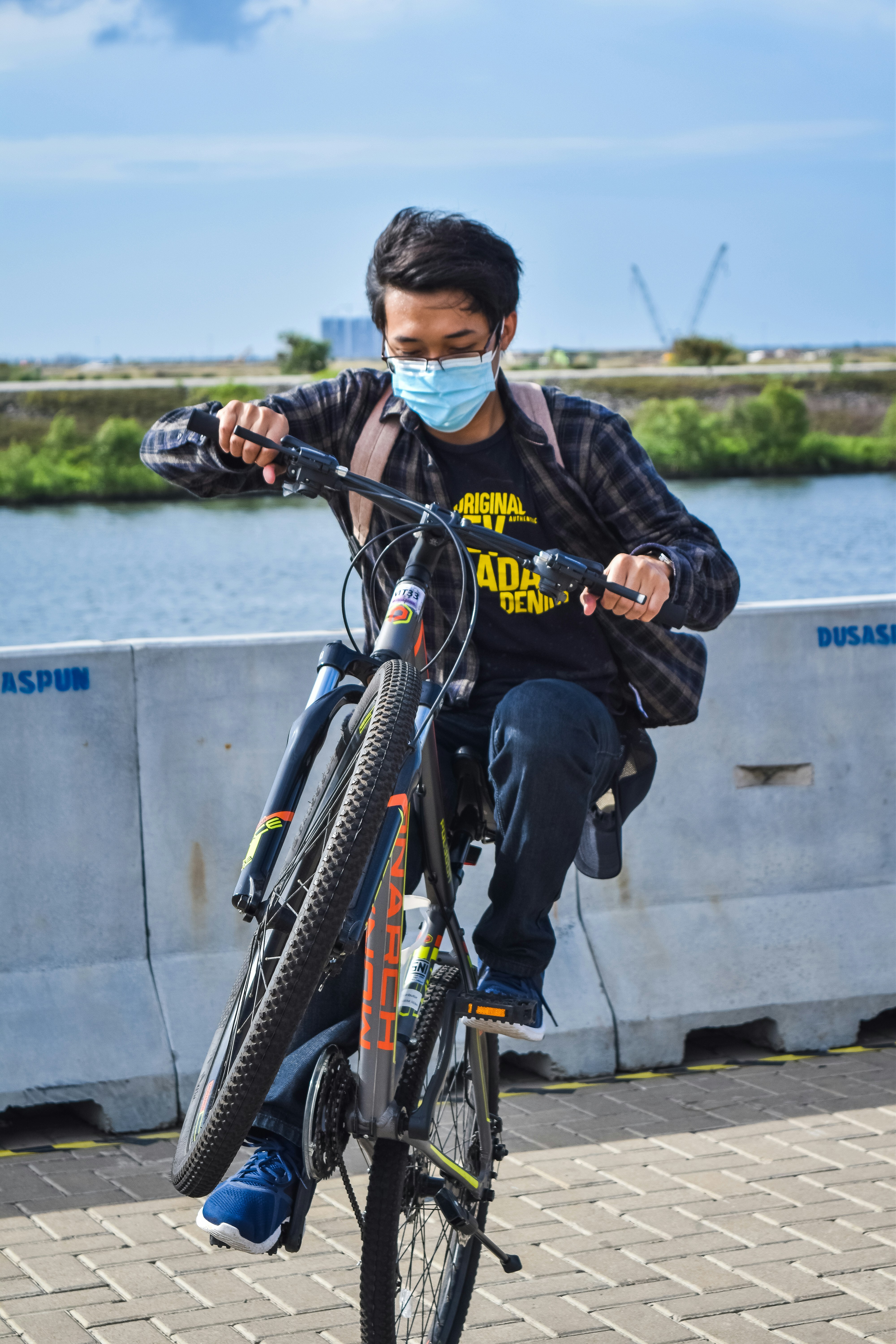 man in black and red jacket riding on black bicycle