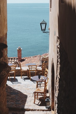 brown wooden chairs on white sand beach during daytime