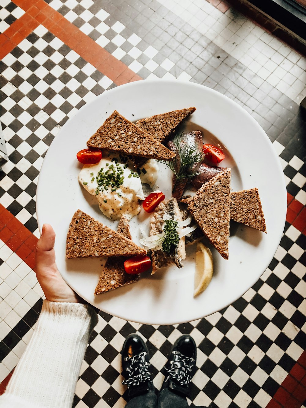 sliced bread with green vegetable on white ceramic plate