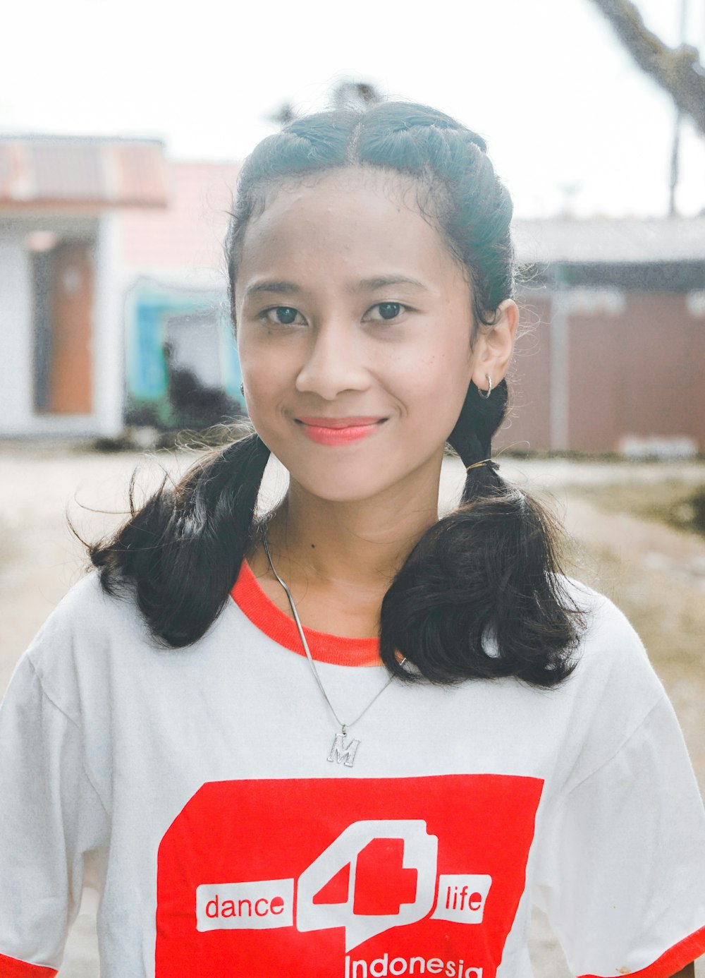 woman in white crew neck t-shirt wearing silver necklace