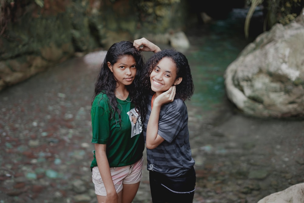 3 women standing near river during daytime