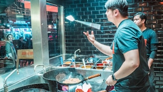 A chef skillfully tossing pasta in a bustling kitchen.