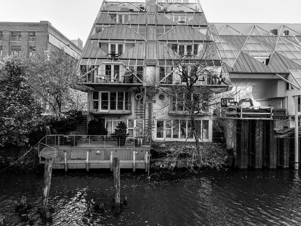 grayscale photo of a building near a river