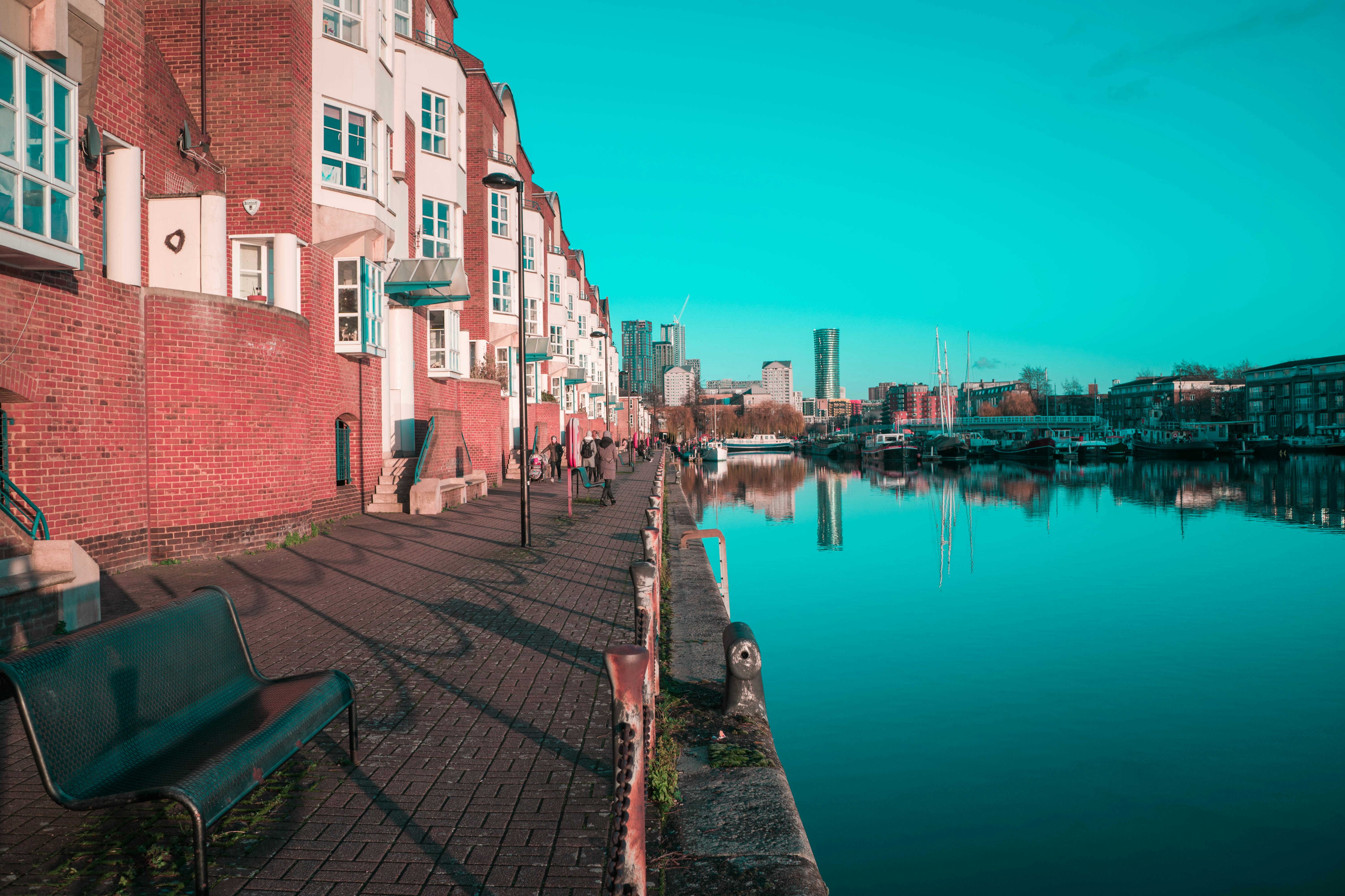 brown concrete building beside body of water during daytime, 