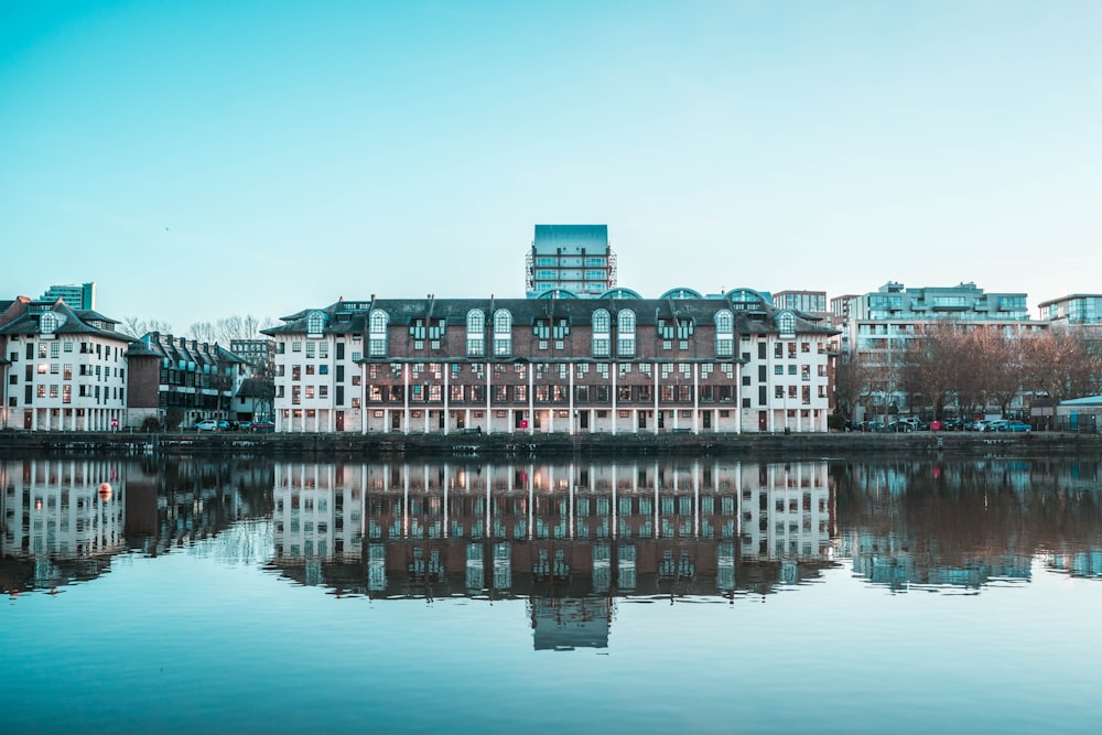 brown and white concrete building near body of water during daytime