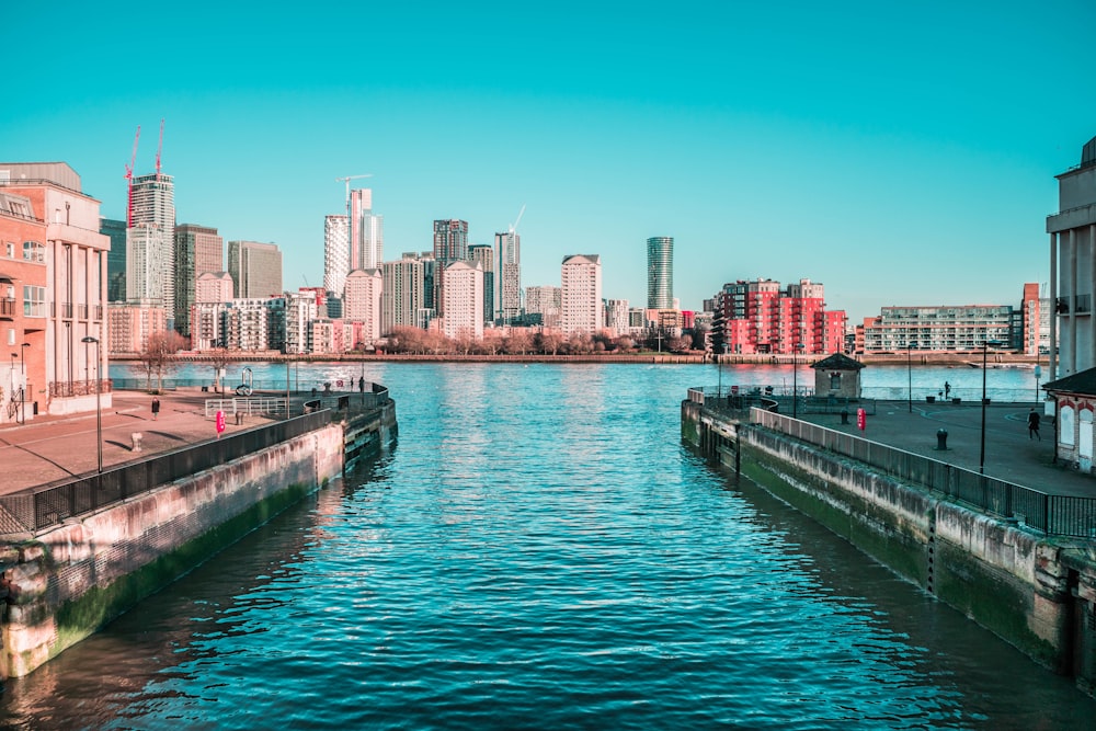 body of water near city buildings during daytime