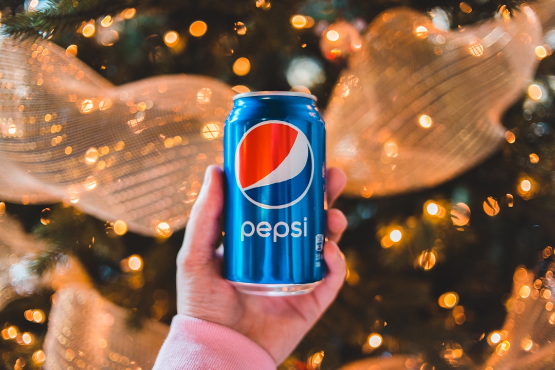 person holding pepsi cola can