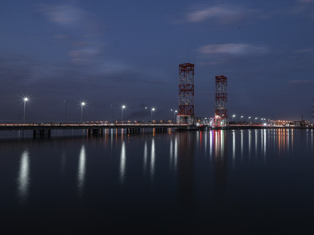 city skyline across body of water during night time