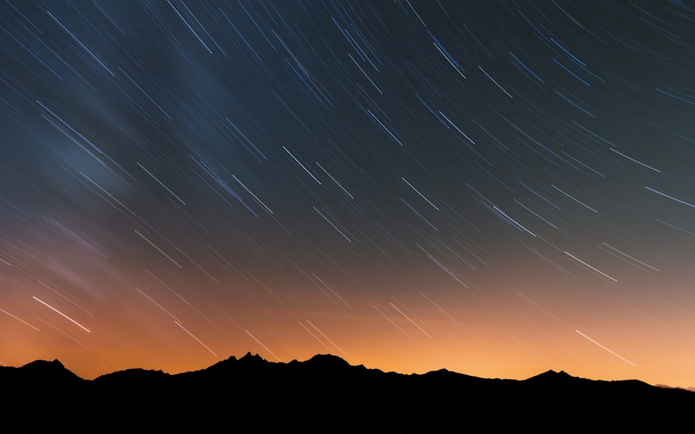 silhouette of mountain during night time