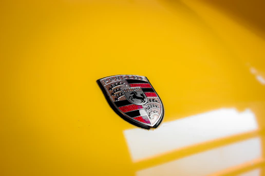 A close-up of a car with a shield icon symbolizing comprehensive auto insurance protection.