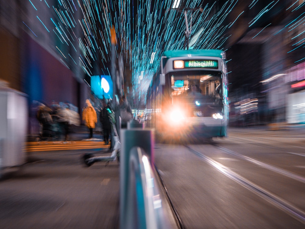 white and black bus on road during night time