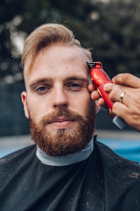 Electric beard trimmer with adjustable guard on a bathroom counter