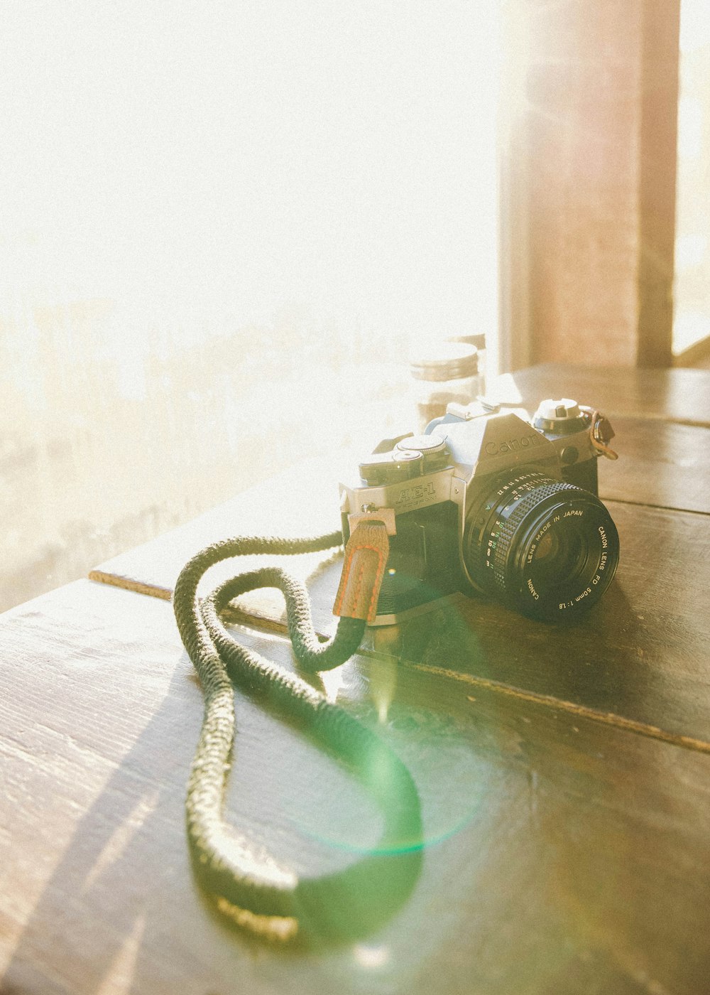 black and silver dslr camera on brown wooden table