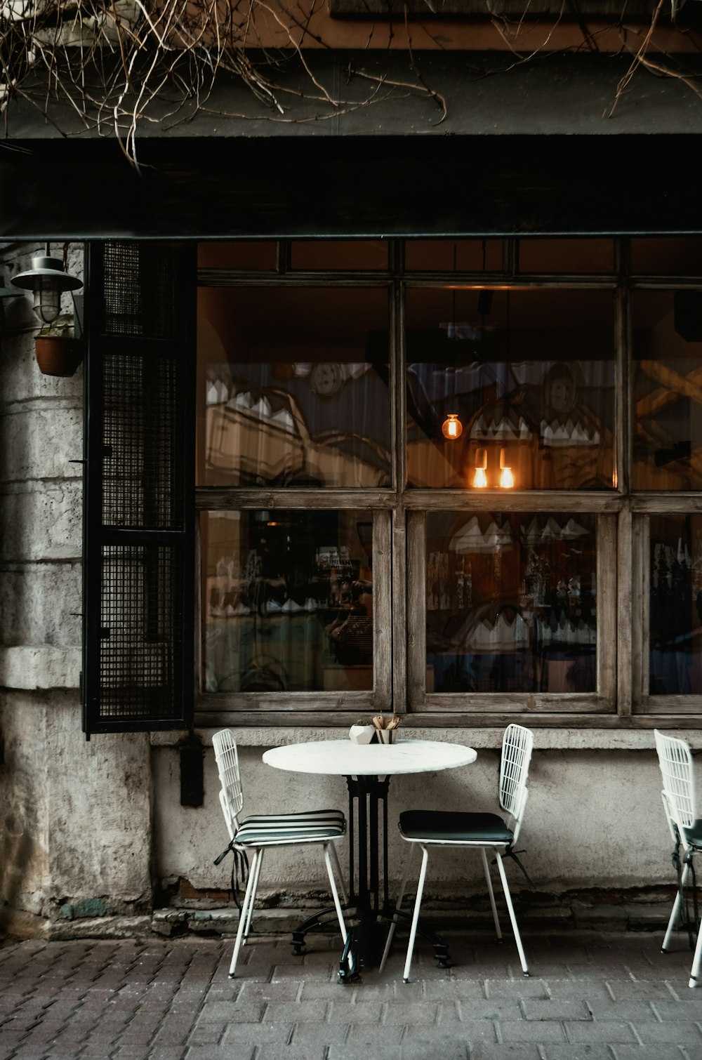 white table and chairs near window