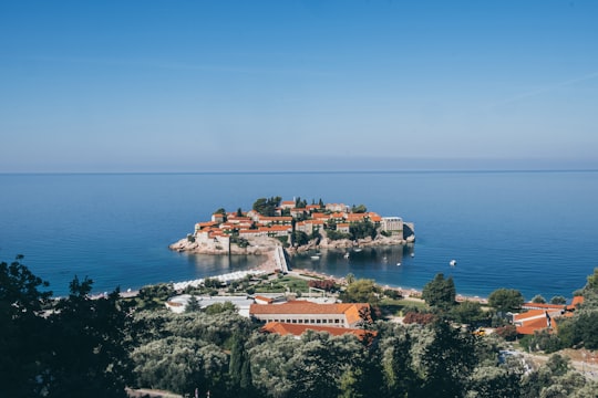 aerial view of city near body of water during daytime in Sveti Stefan Montenegro