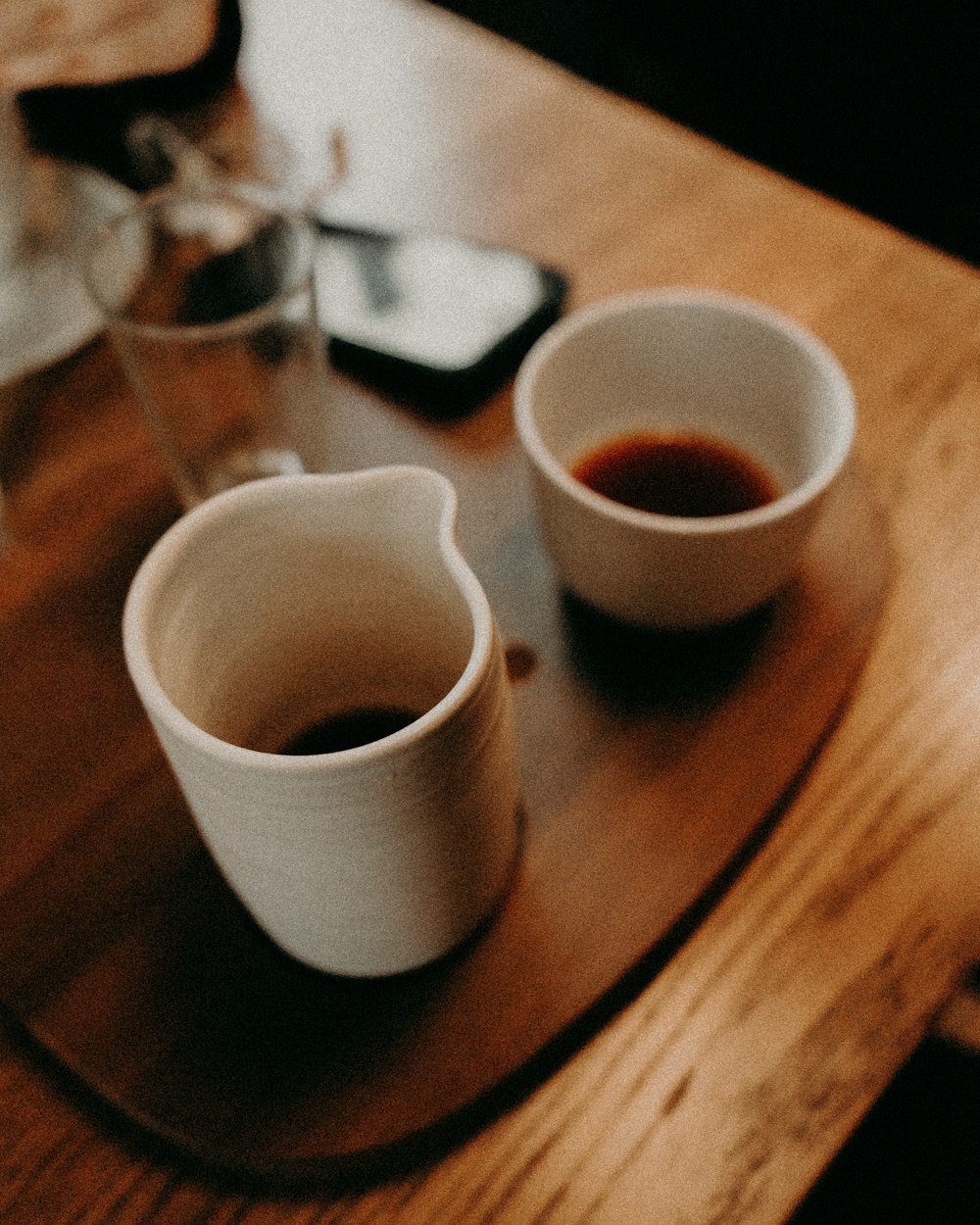 white ceramic mug on brown wooden table