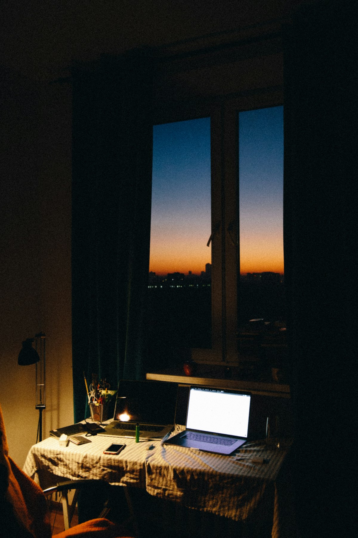 Black laptop on a brown wooden table, focused-work register