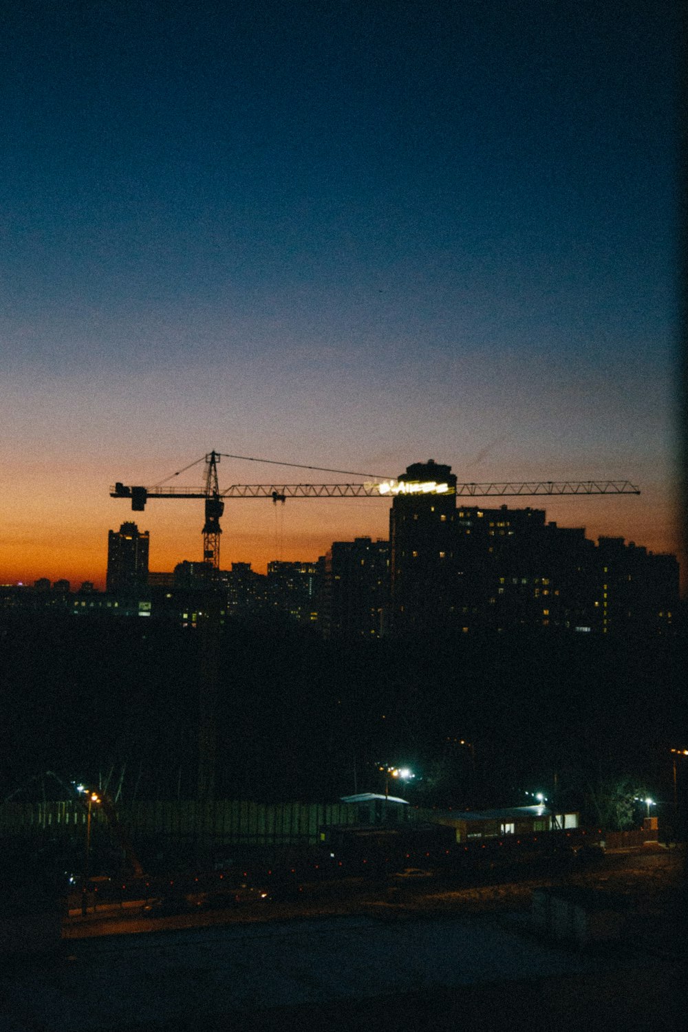 silhouette of city buildings during night time