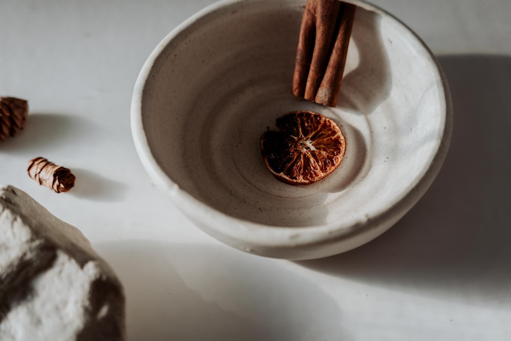 brown stick on white ceramic bowl