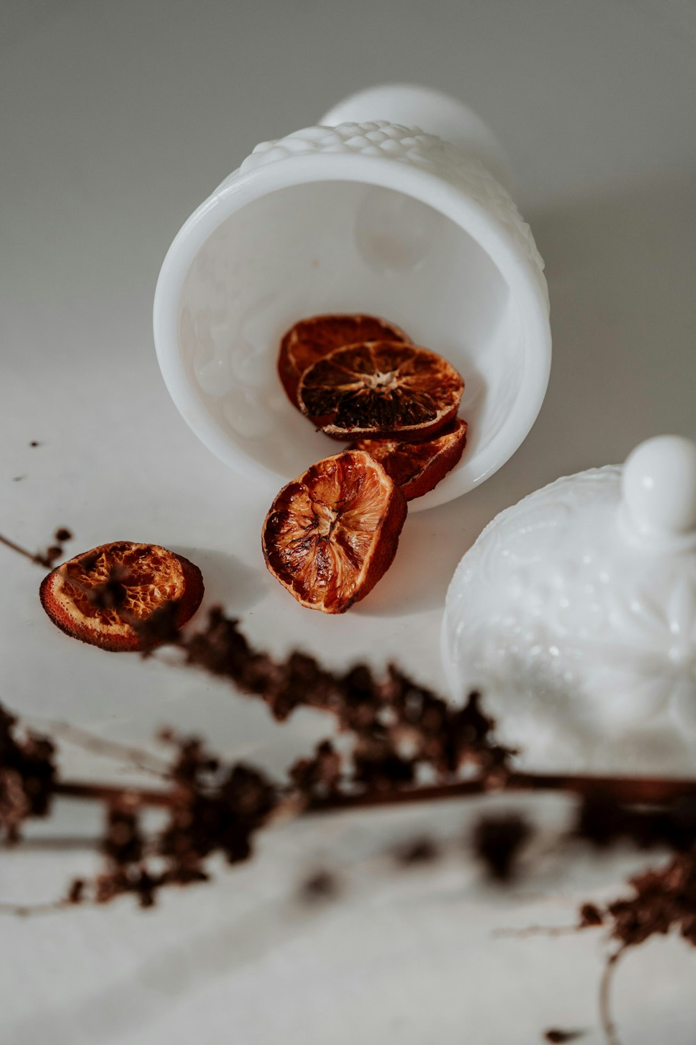 white ceramic bowl with brown leaves