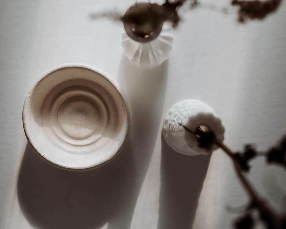 white ceramic vase with white flower