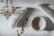 Hands gently arranging simple, natural elements on a clean wooden surface.