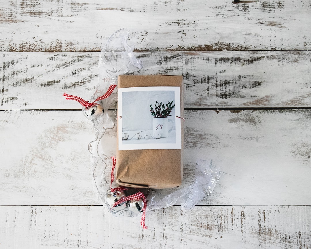 brown and white greeting card on white textile