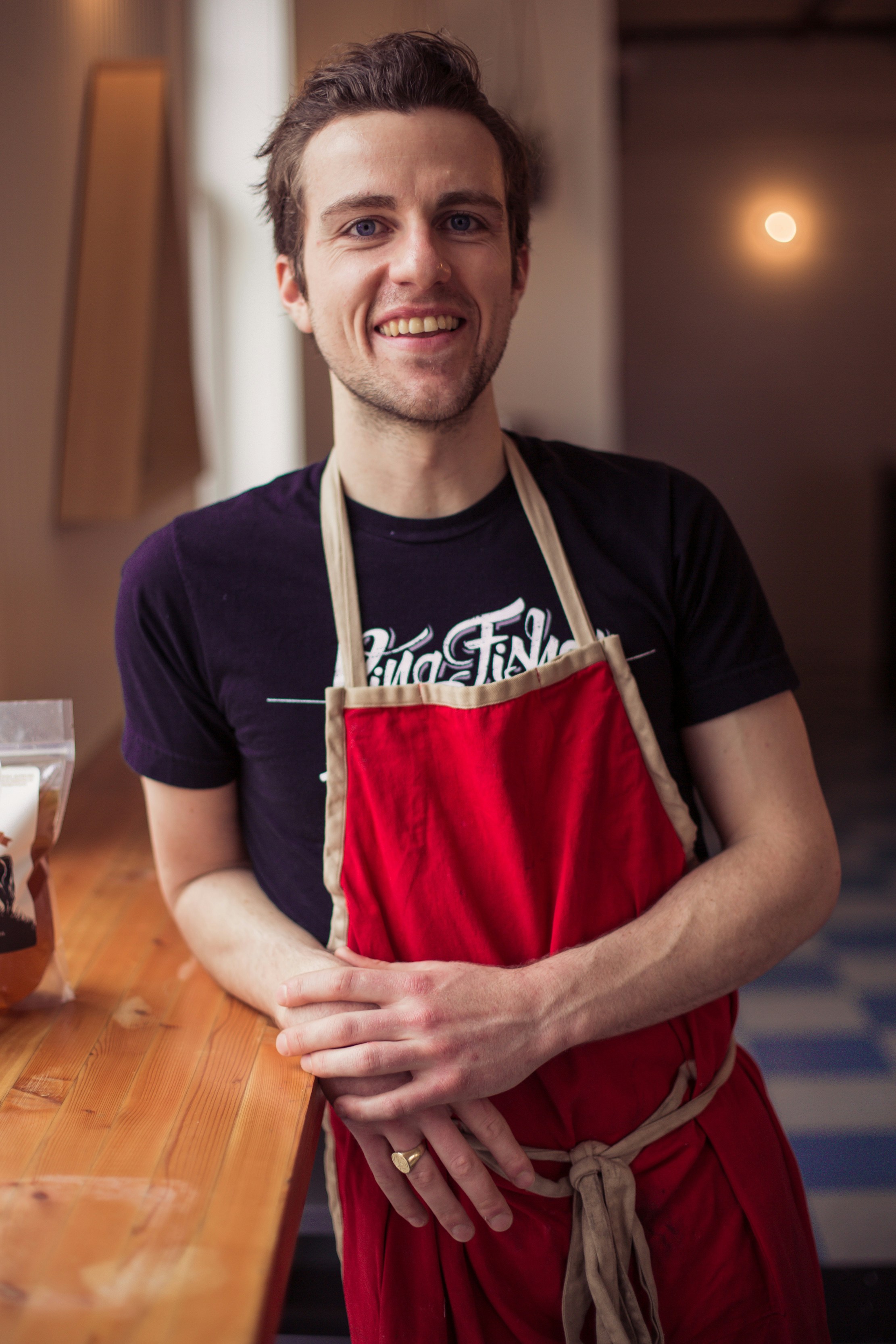 great photo recipe,how to photograph chef in red apron ; man in black crew neck t-shirt smiling