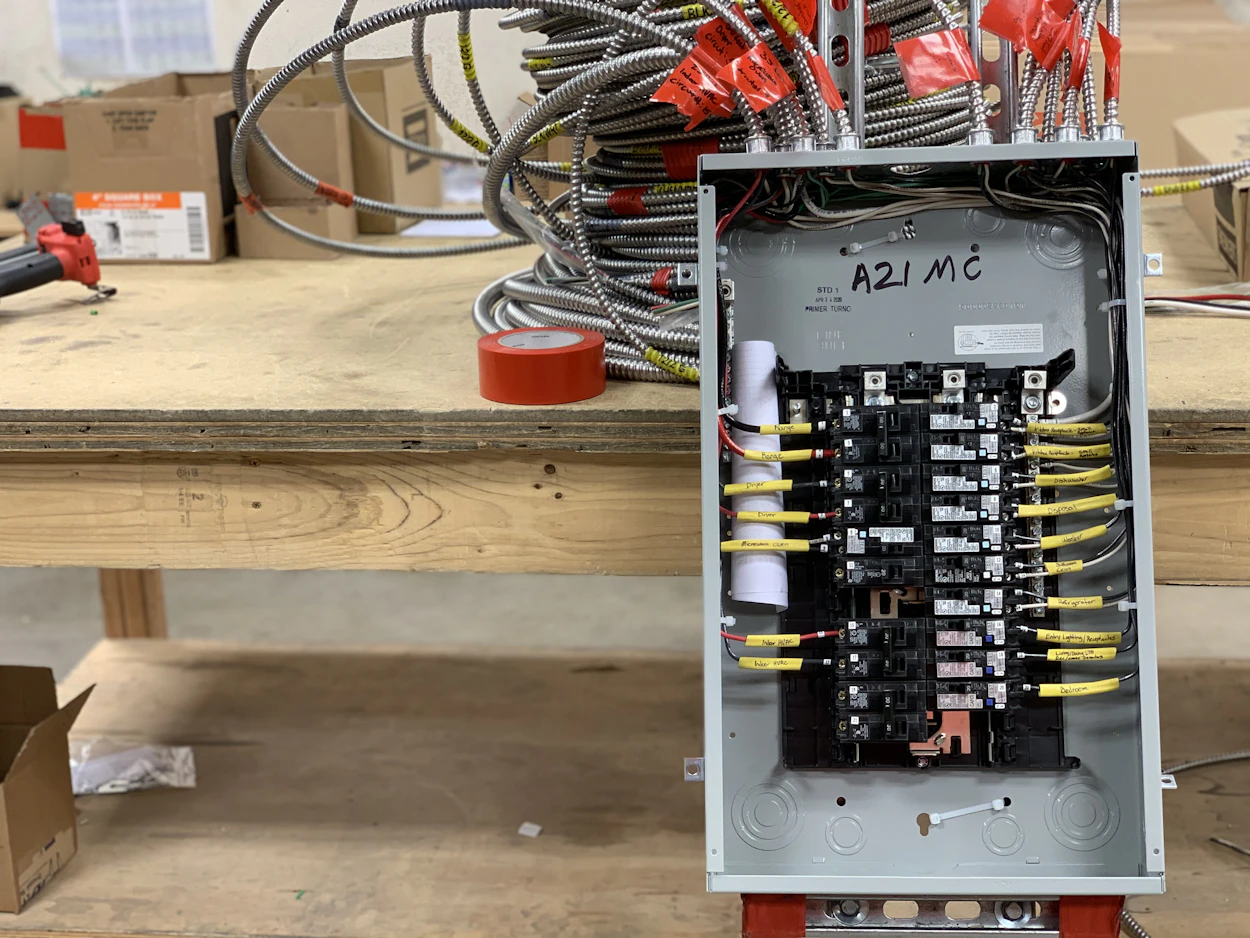 A new breaker panel wired and labeled on a workbench