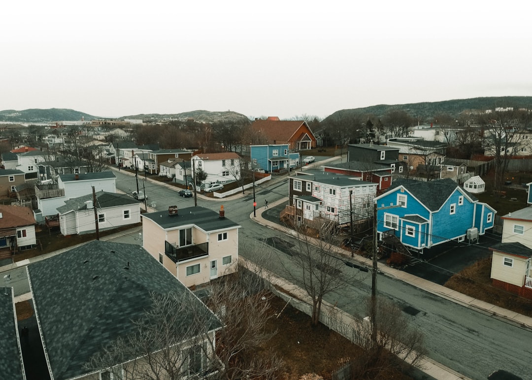 white and blue houses on hill