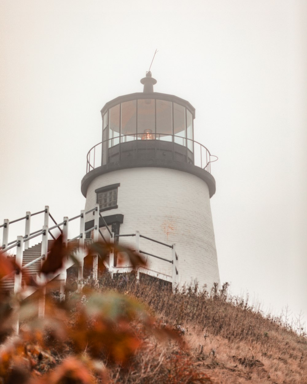 white and black lighthouse under white sky during daytime