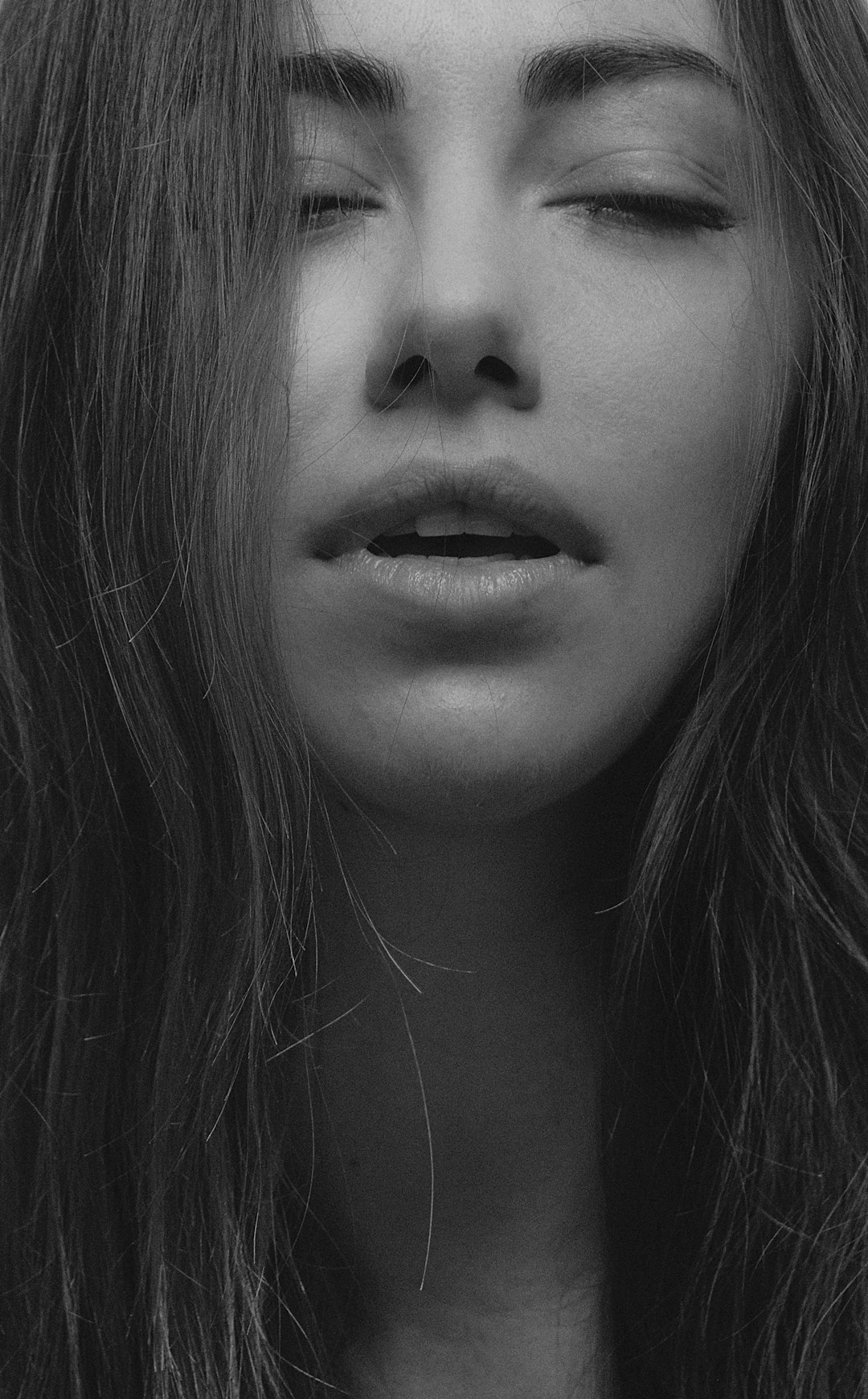 grayscale photo of womans face