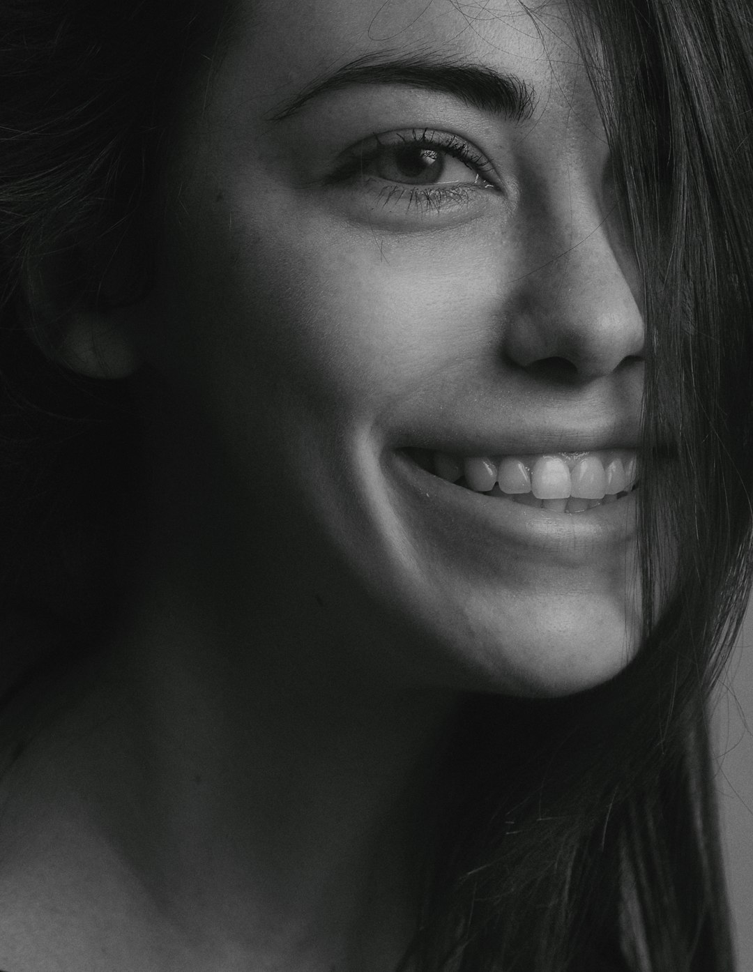 smiling woman in grayscale photography