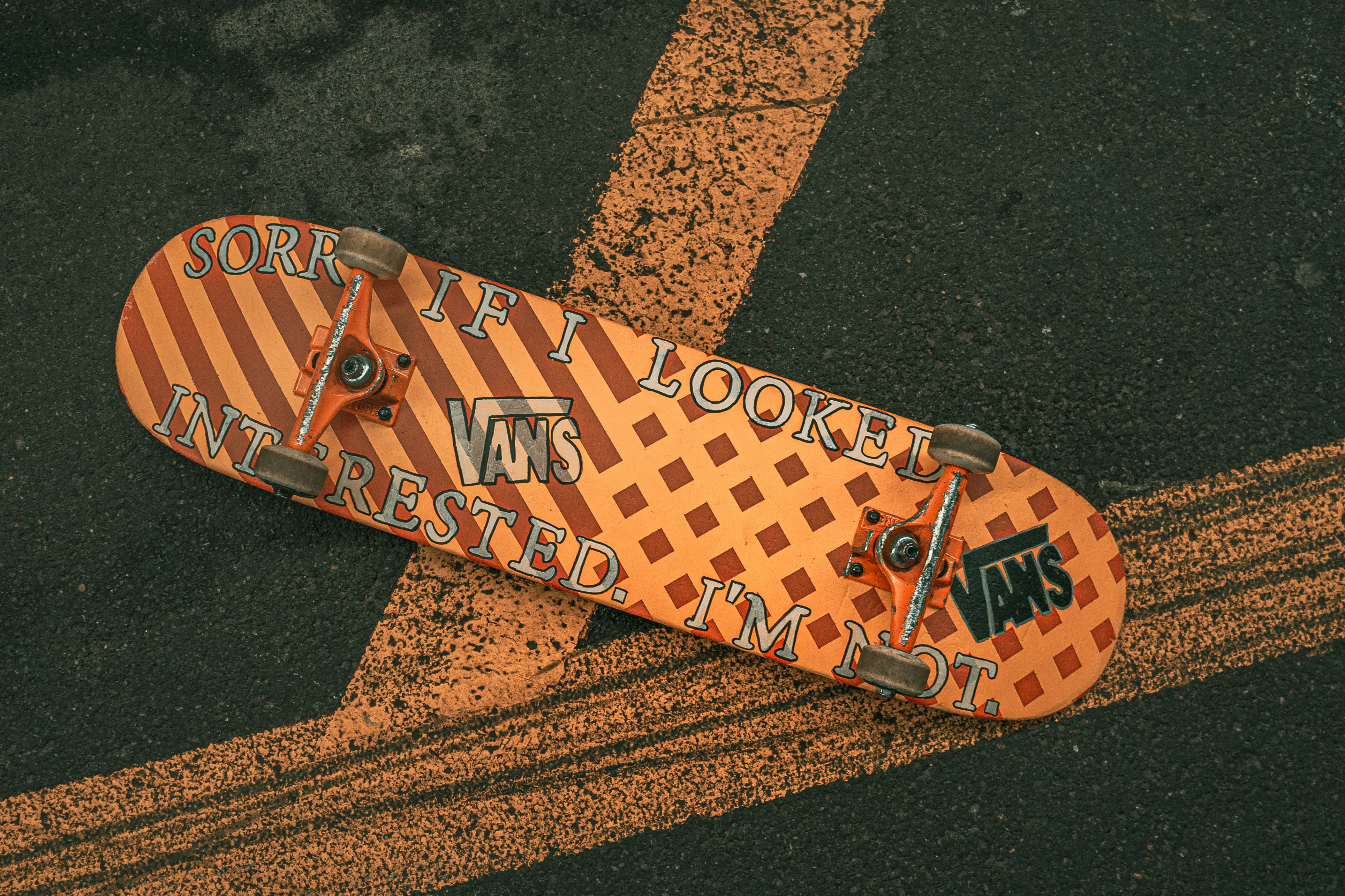 yellow and black skateboard on black asphalt road