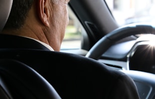 man in black shirt driving car