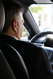 man in black shirt driving car