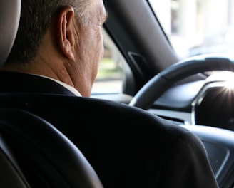 man in black shirt driving car