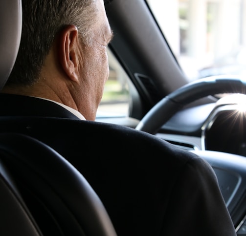 man in black shirt driving car