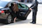 A friendly driver assisting a middle-aged man with a walker into a spacious vehicle.