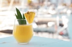 yellow juice in clear drinking glass