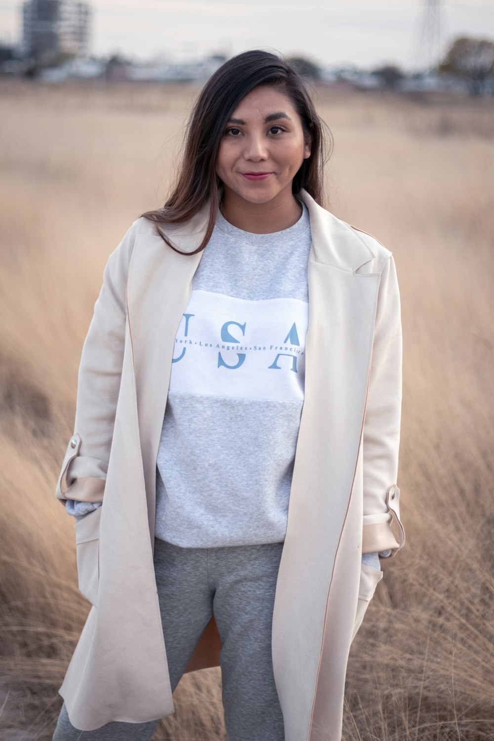 woman in white coat and gray shirt