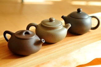 black ceramic teapot on brown wooden table