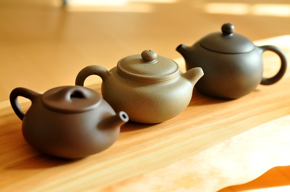 black ceramic teapot on brown wooden table