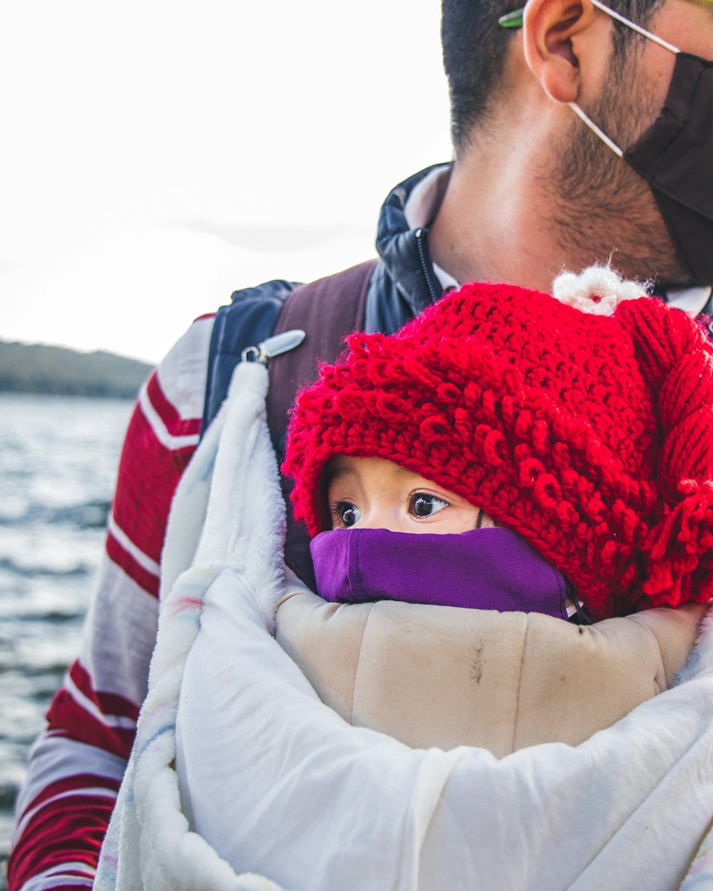 woman in red knit cap and white jacket