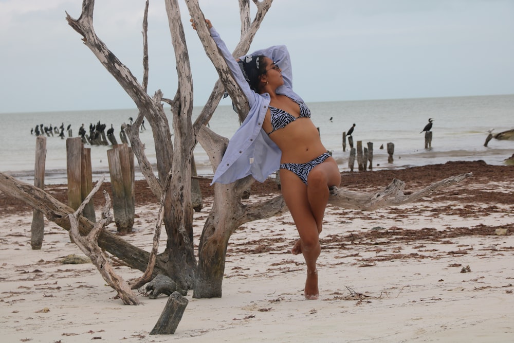 woman in blue bikini standing on beach during daytime