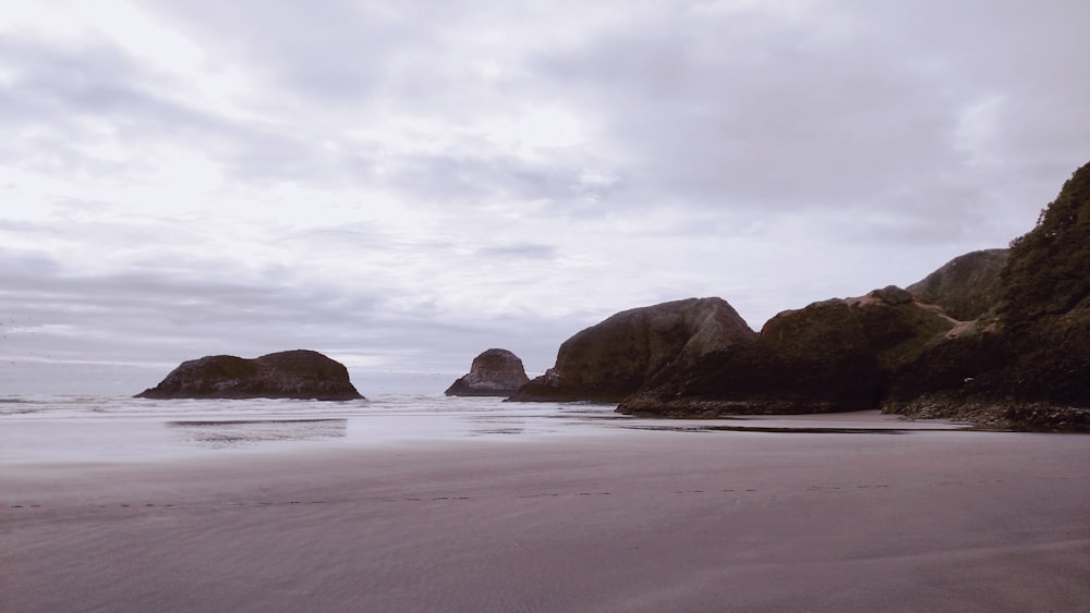 brown rock formation on sea shore during daytime