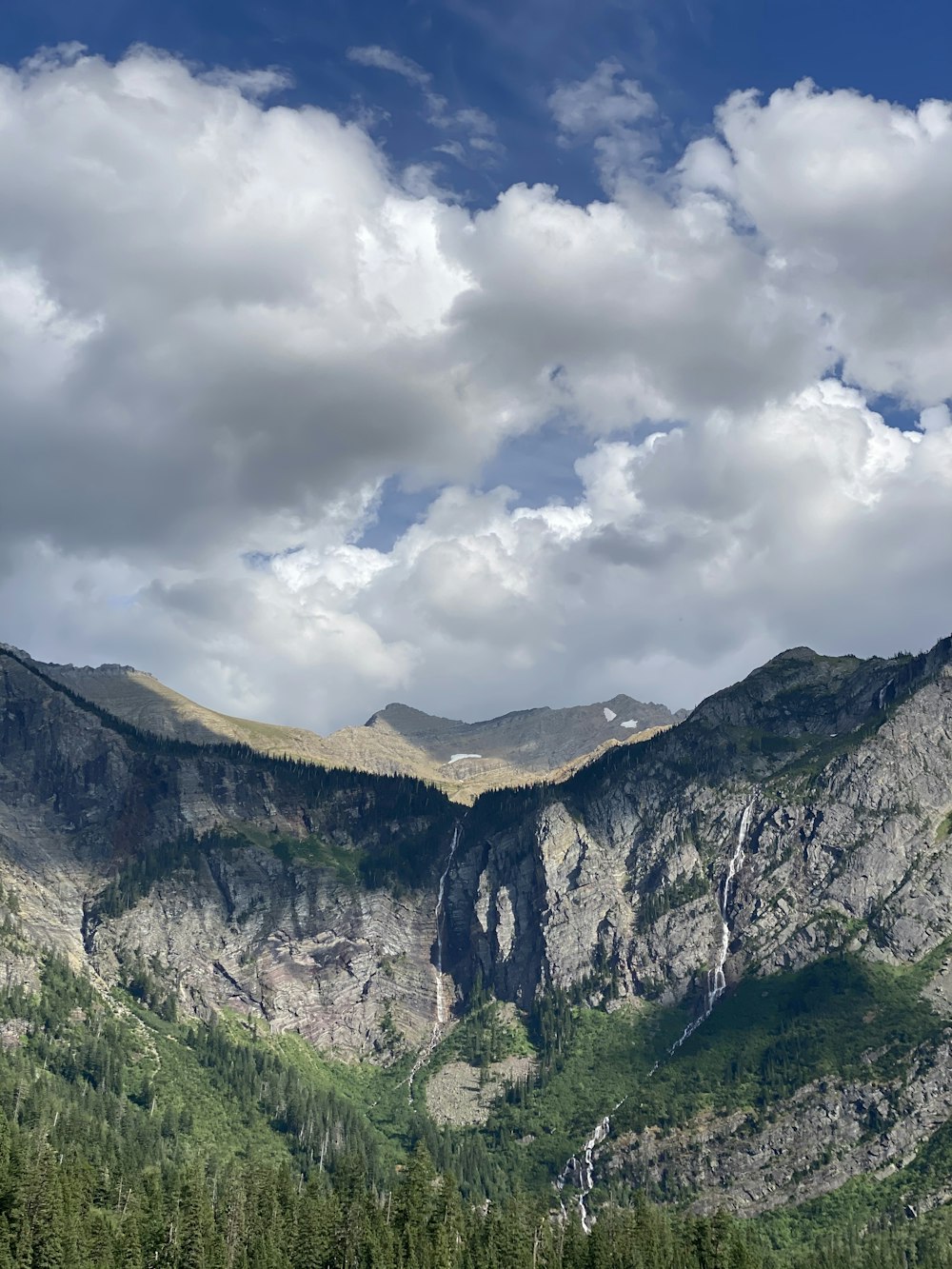 green and brown mountain under white clouds during daytime