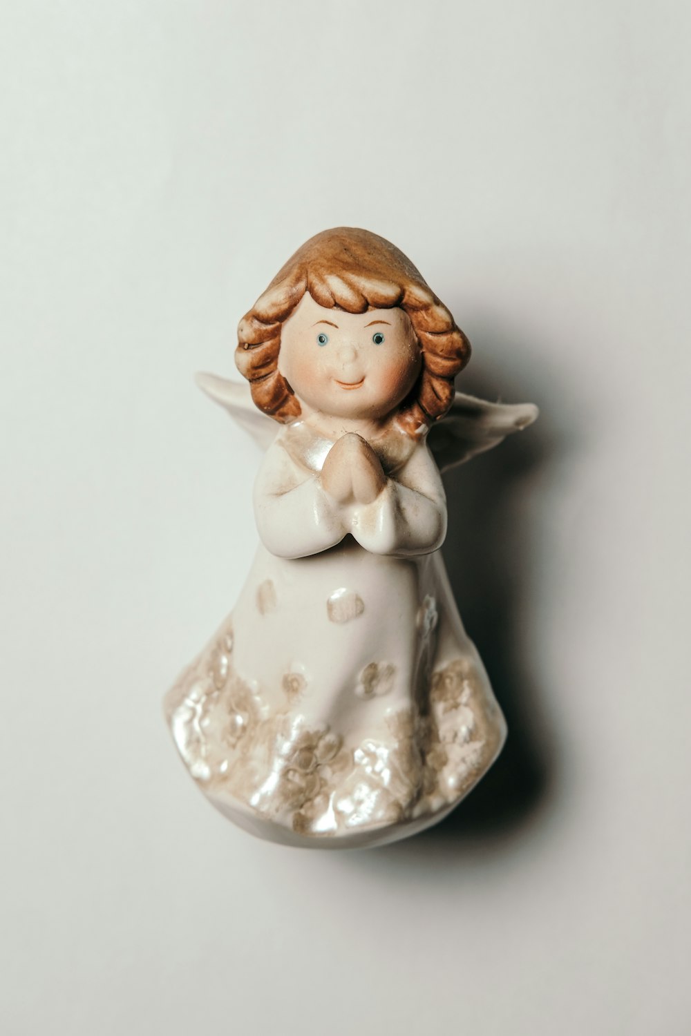 angel ceramic figurine on white surface